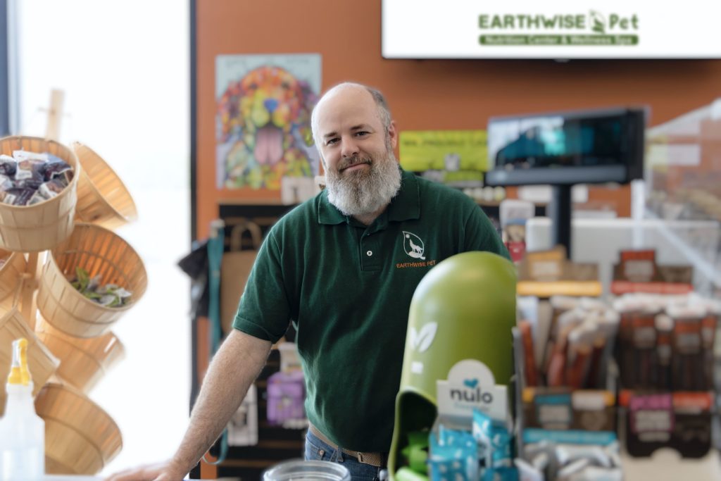 EarthWise Pet Franchisee Smiling at the Store Counter